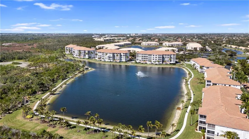 Drone / aerial view of a nearby body of water and apartment complex