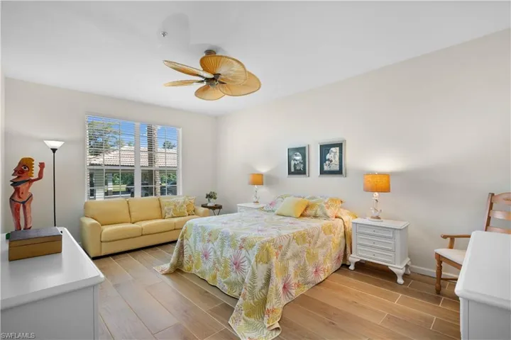Bedroom featuring wood tiled floors and a ceiling fan