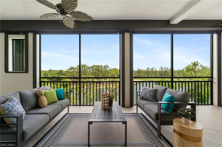 Sunroom featuring an outdoor hangout area, ceiling fan, and beamed ceiling