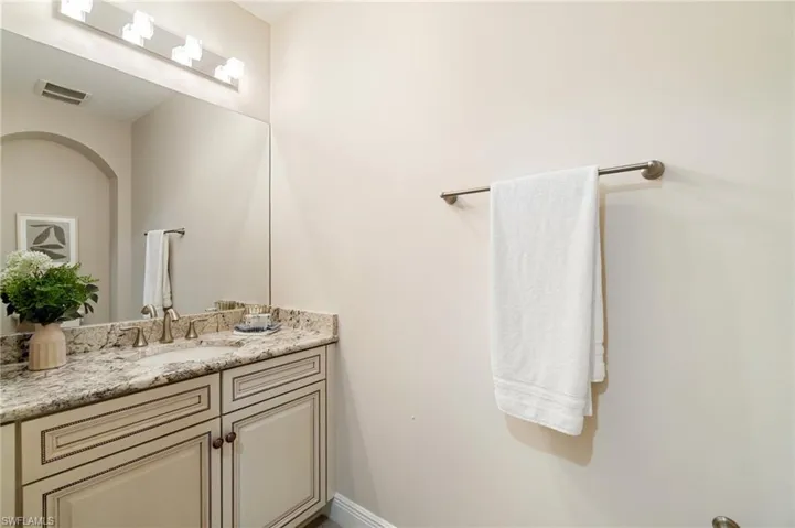 Bathroom featuring vanity and baseboards