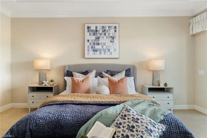 Bedroom featuring carpet, crown molding, and baseboards