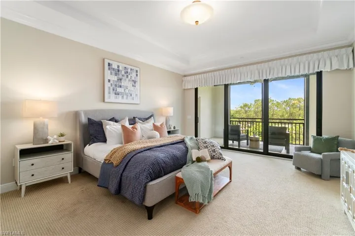 Carpeted bedroom featuring access to exterior and ornamental molding