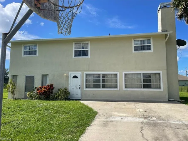 View of front of home with a patio area and a front lawn