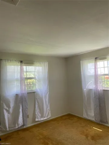 Empty room with carpet floors