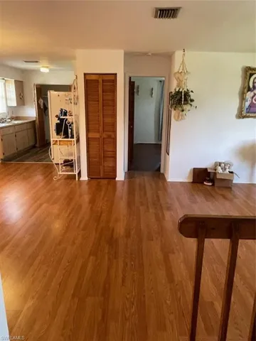 Hallway with dark hardwood / wood-style floors and sink