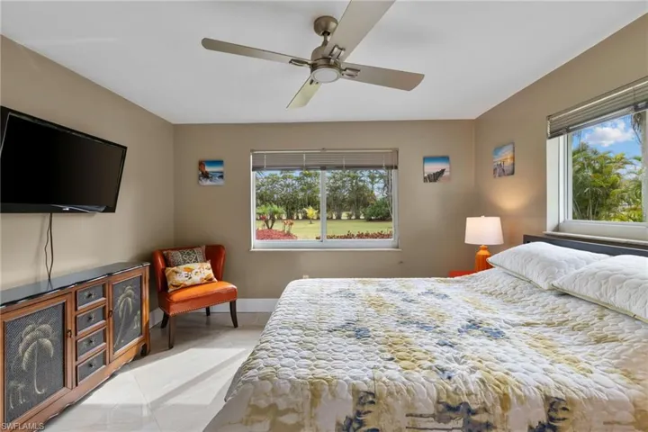 Bedroom with multiple windows, baseboards, and a ceiling fan