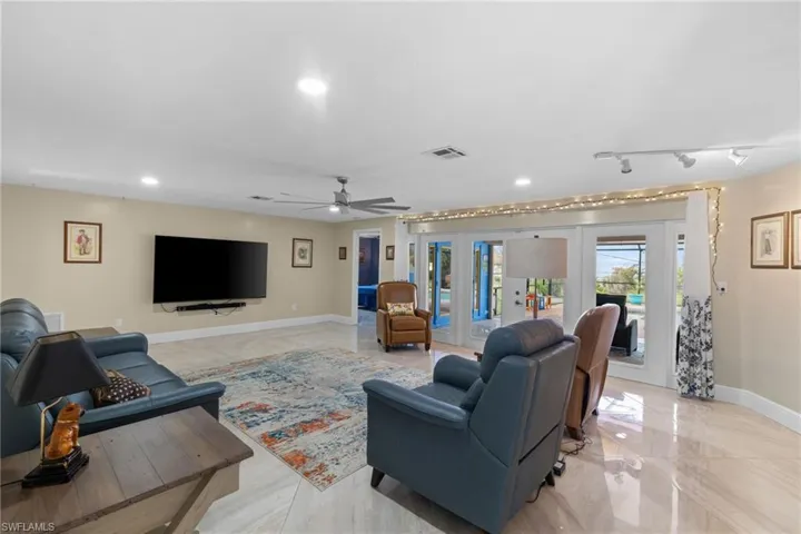 Living area with recessed lighting, baseboards, visible vents, and french doors