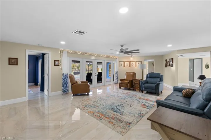 Living room with french doors, marble finish floor, recessed lighting, visible vents, and baseboards