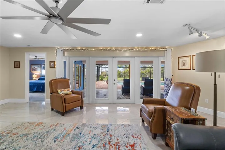 Sitting room featuring recessed lighting, baseboards, ceiling fan, and french doors