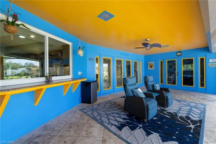 View of patio with a ceiling fan and french doors