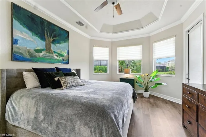 KING BED IN PRIMARY BEDROOM WITH 2 WALK-IN CLOSETS, BAY WINDOWS, DOOR TO LANAI AND PRIVATE EN-SUITE BATHROOM, LUXURY VINYL FLOORS