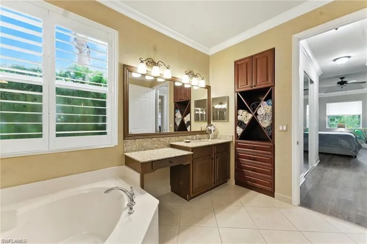 PRIMARY BATHROOM FEATURES 2 SINK AREAS, TOWEL ORGANIZER WITH DRAWERS, VANITY, SOAKING TUB, WALK-IN SHOWER, SEPARATE TOILET, AND GRAB BARS IN SHOWER AND BATHROOM