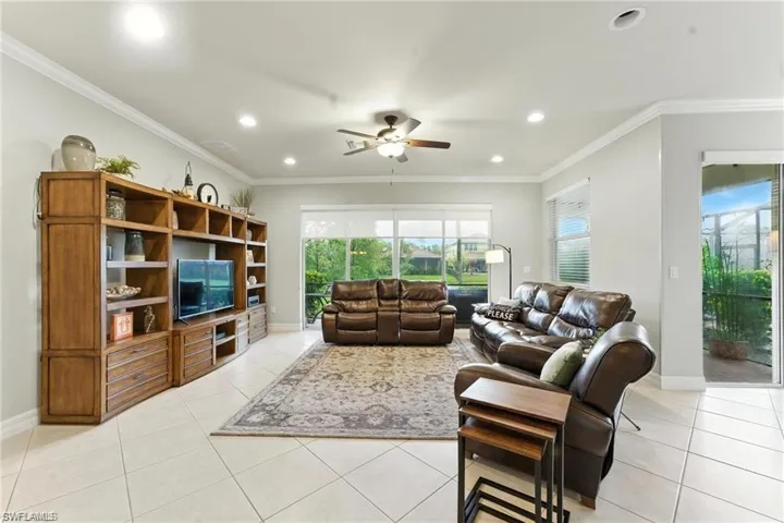 OPEN FLOOR PLAN WITH LARGE ENTERTAINMENT UNIT AND FURNITURE. LOTS OF LIGHT AND SLIDERS TO OUTSIDE LANAI SPACE