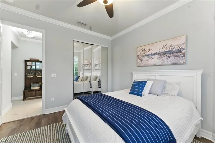 FRONT BEDROOM WITH CUSTOM CLOSET SHELVES, JUST OUTSIDE THE BEDROOM IS A BATHROOM WITH TUB/SHOWER COMBO