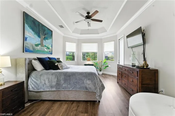 KING BED IN PRIMARY BEDROOM WITH 2 WALK-IN CLOSETS, BAY WINDOWS, DOOR TO LANAI AND PRIVATE EN-SUITE BATHROOM, LUXURY VINYL FLOORS