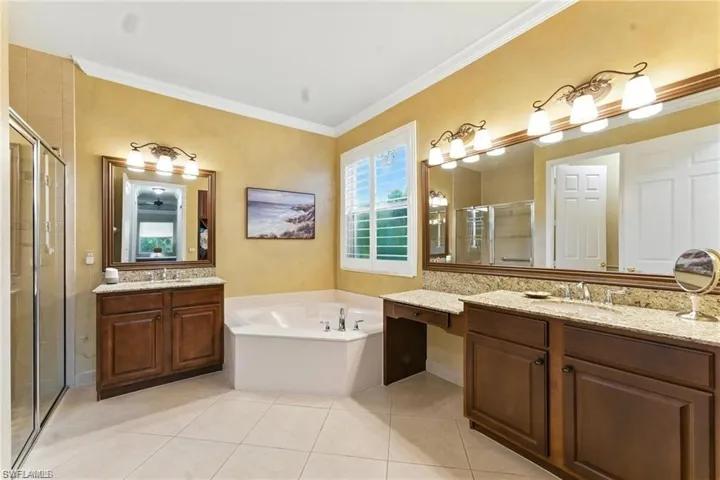 PRIMARY BATHROOM FEATURES 2 SINK AREAS, TOWEL ORGANIZER WITH DRAWERS, VANITY, SOAKING TUB, WALK-IN SHOWER, SEPARATE TOILET, AND GRAB BARS IN SHOWER AND BATHROOM