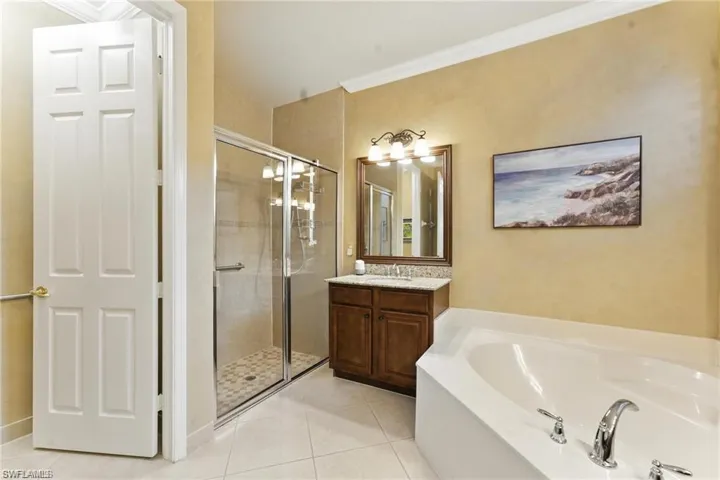 PRIMARY BATHROOM FEATURES 2 SINK AREAS, TOWEL ORGANIZER WITH DRAWERS, VANITY, SOAKING TUB, WALK-IN SHOWER, SEPARATE TOILET, AND GRAB BARS IN SHOWER AND BATHROOM