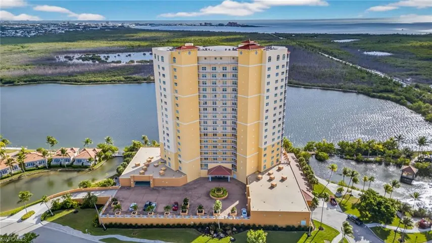 Drone / aerial view of apartment complex / building and a nearby body of water