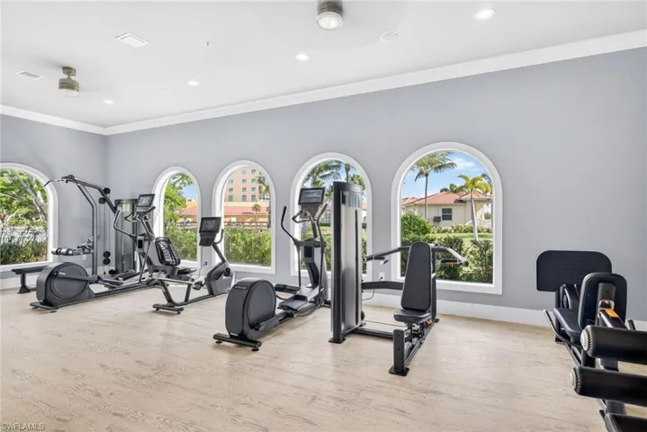 Workout room featuring crown molding and recessed lighting