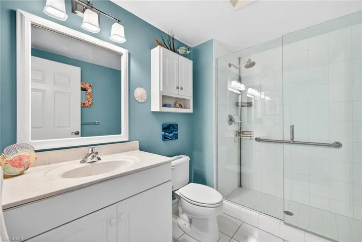 Bathroom featuring vanity, a stall shower, and light tile patterned flooring