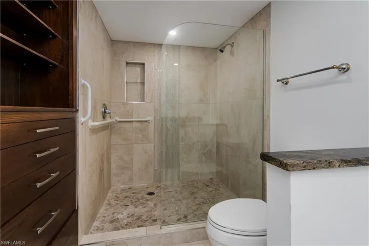 Bathroom with tiled shower and toilet