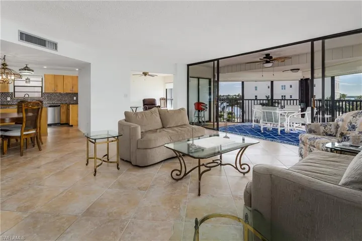 Living room featuring light tile patterned floors, a textured ceiling, and ceiling fan