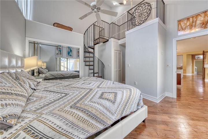 Primary bedroom with a spiral staircase