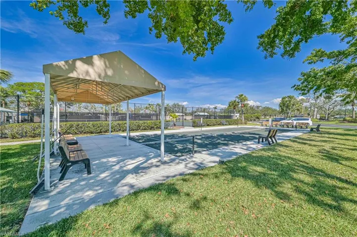 Covered seating area featuring a sturdy metal frame and tan canopy