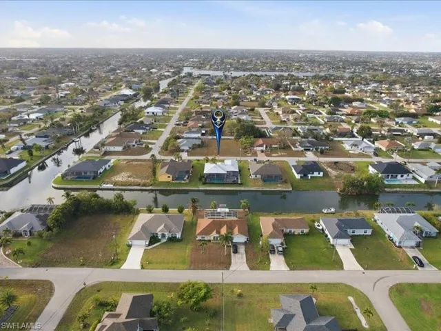Aerial overview of property's location featuring nearby suburban area and a large body of water