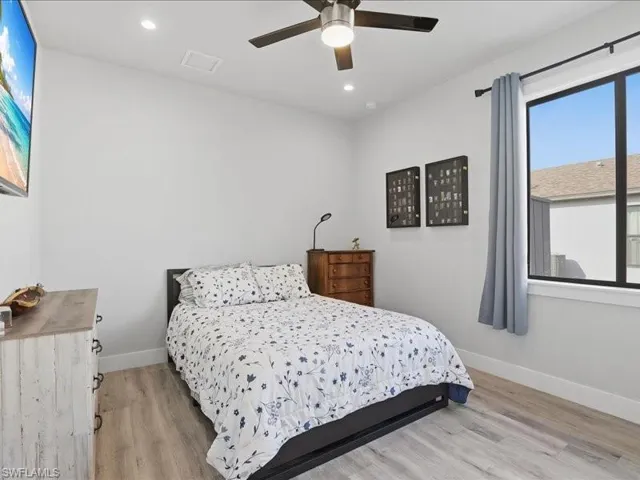 Bedroom featuring light wood-type flooring, recessed lighting, and a ceiling fan