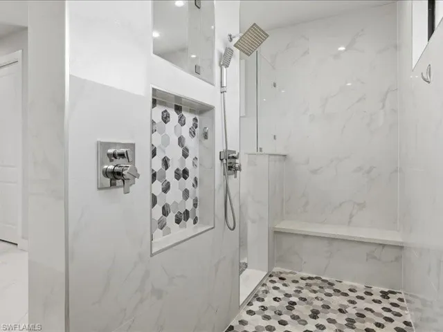 Bathroom featuring a marble finish shower