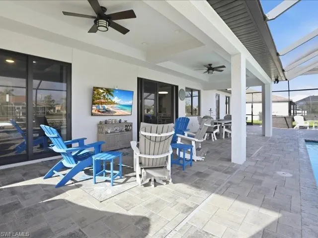View of patio / terrace with ceiling fan, a lanai, a sunroom, outdoor dining space, and an outdoor pool