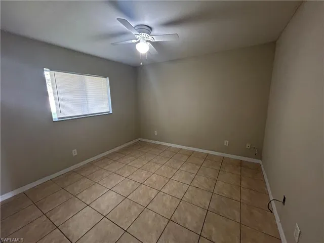 Unfurnished bedroom featuring light tile patterned floors and a closet