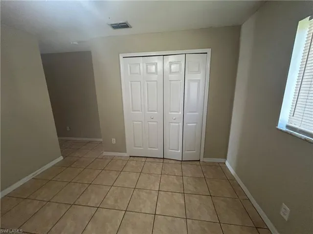 Full bath featuring vanity, bathing tub / shower combination, and light tile patterned floors