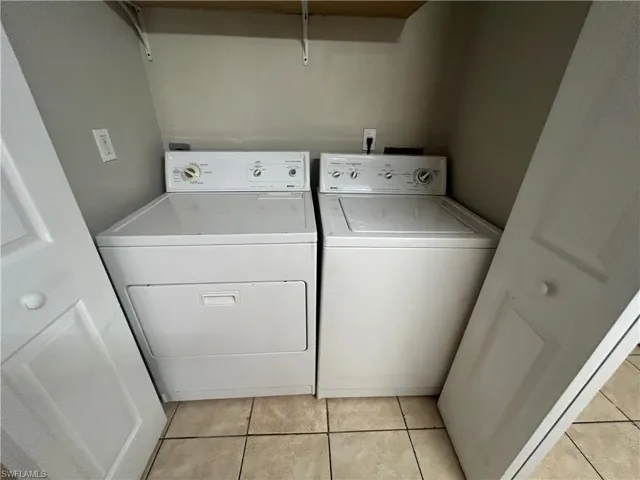 Unfurnished room featuring a ceiling fan and light tile patterned floors