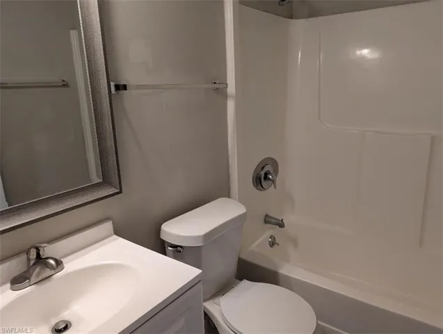 Full bathroom with  shower combination, vanity, and toilet