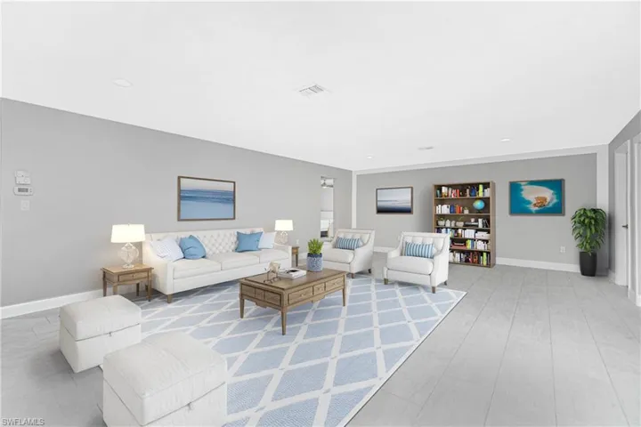 Living room featuring light wood-type flooring and built in shelves