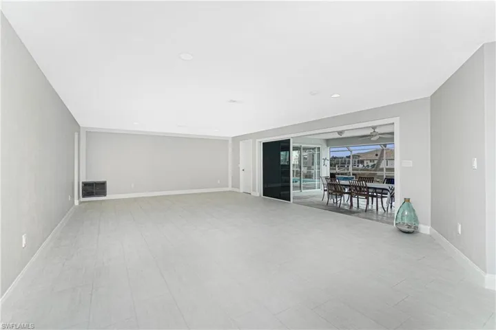 Unfurnished living room featuring ceiling fan
