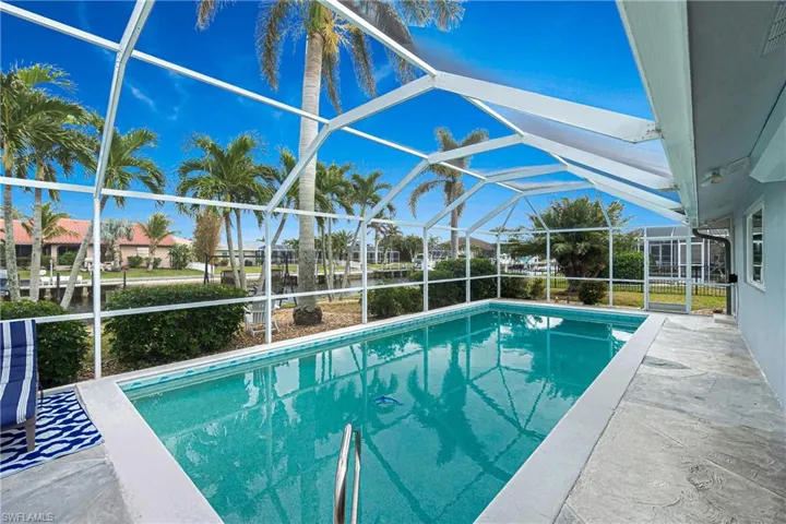 View of pool featuring a patio area and a lanai
