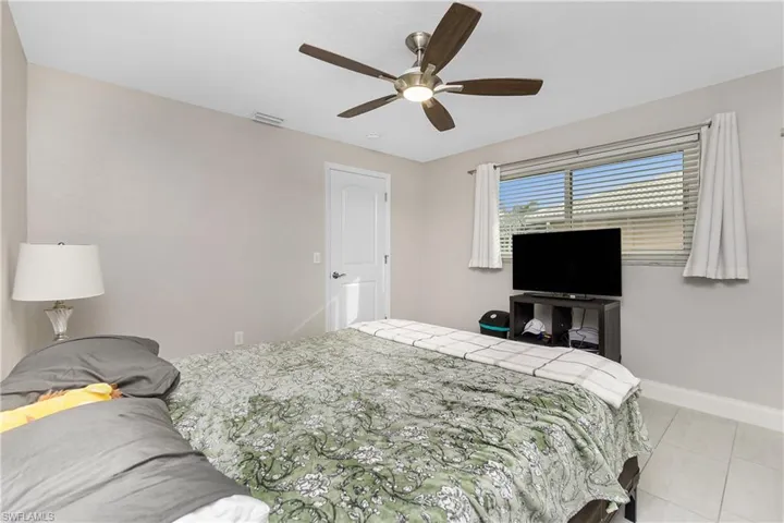 Bedroom featuring light tile patterned flooring and ceiling fan