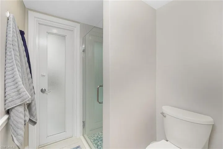 Bathroom with a shower with door and toilet