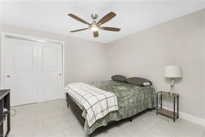 Bedroom featuring ceiling fan and a closet