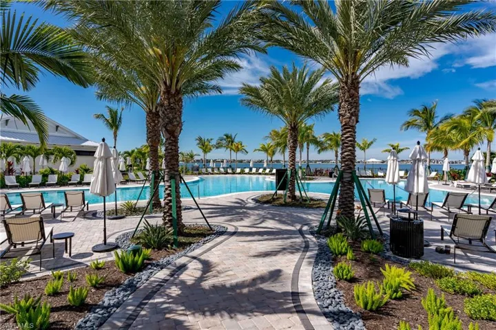 View of swimming pool featuring a patio and central air condition unit