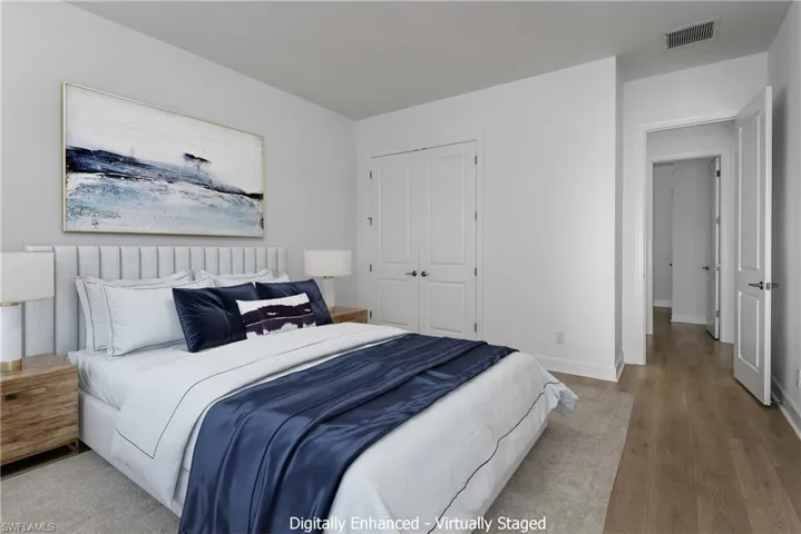 Bedroom with wood-type flooring and a closet