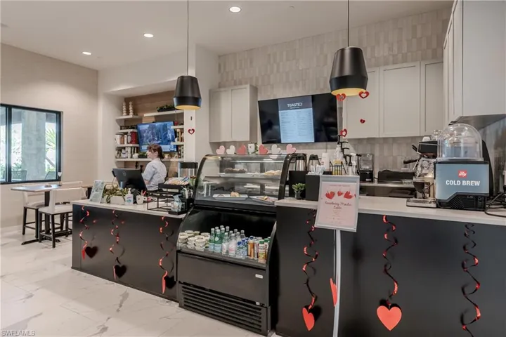 Kitchen featuring backsplash, light tile floors, and pendant lighting