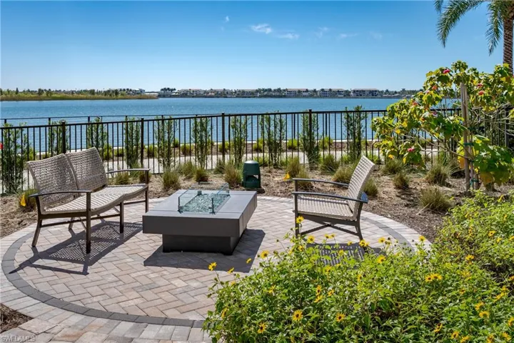 View of patio with a water view and a fire pit