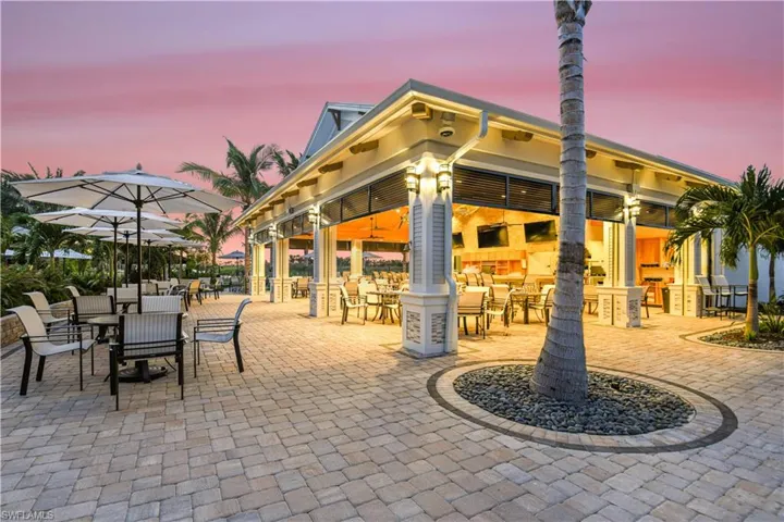 Patio terrace at dusk featuring exterior bar