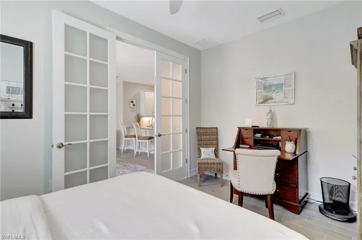 Bedroom featuring light wood-type flooring, french doors, and ceiling fan