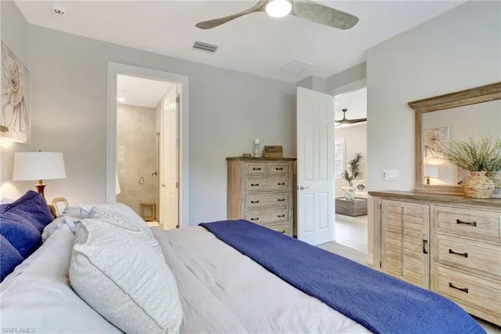 Bedroom featuring ensuite bathroom and ceiling fan