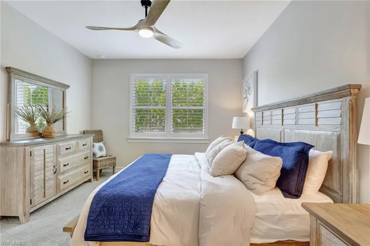 Carpeted bedroom with ceiling fan